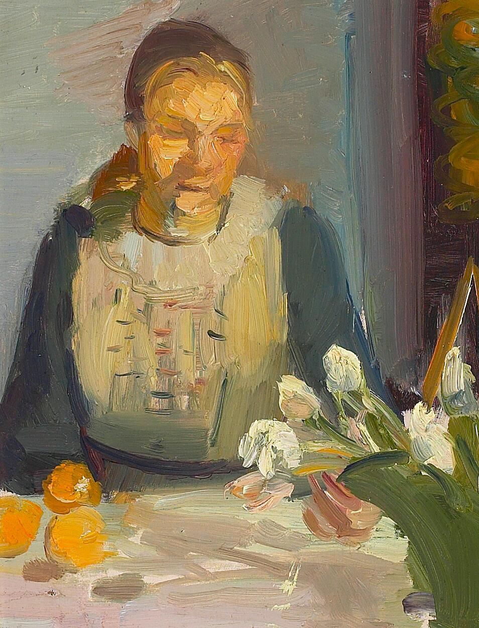 Portrait of Maren Brems sitting at a sunlit table with white and pink tulips in a green vase.